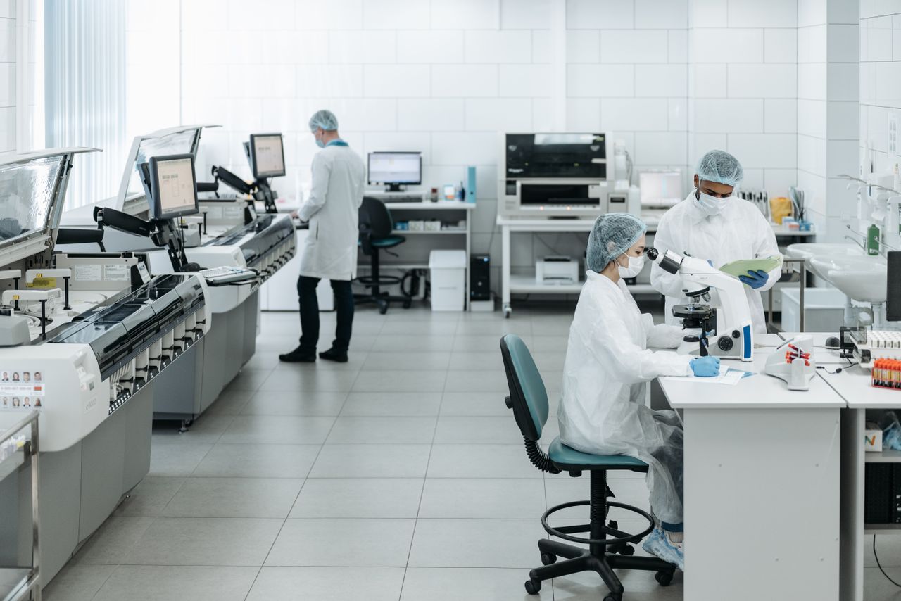 Researchers in lab coats performing experiments with advanced DNA Test in a laboratory. by EVIDEXA DNA Test Solution Pvt Ltd