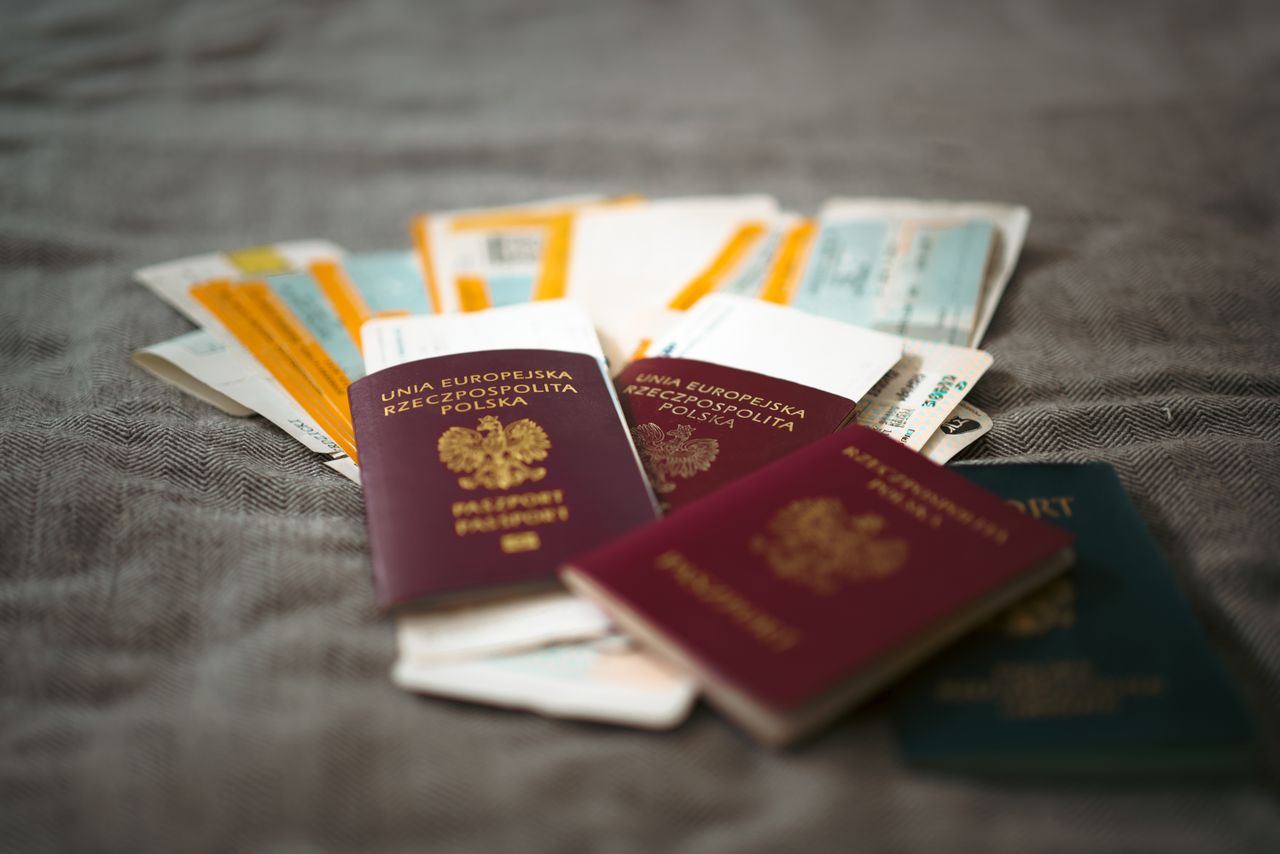 Close-up of Polish passports and travel tickets symbolizing travel and adventure for immigration dna test by EVIDEXA DNA Test solution Pvt Ltd