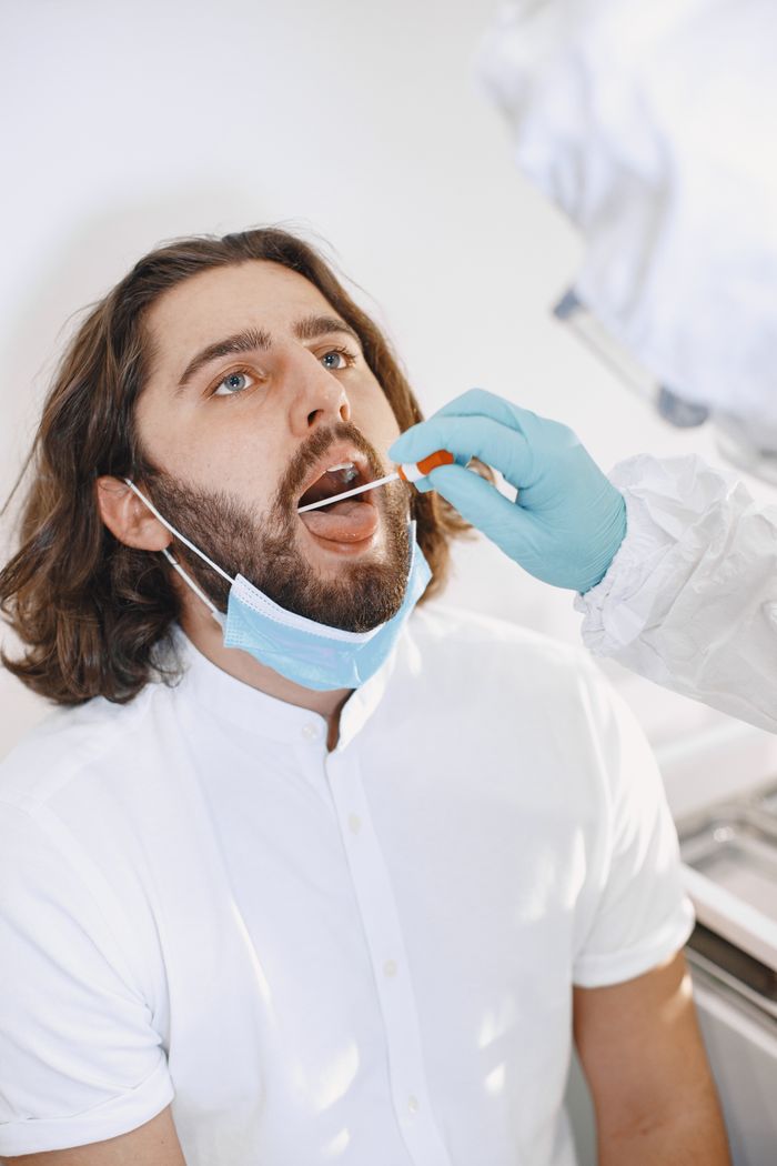 Person providing a buccal mouth swab sample for accurate and non-invasive DNA testing at DNA Forensics Test Solutions.